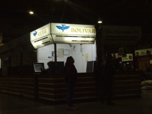 Marktschreierin/ Busticketverkäuferin im Nebenerwerb und im Profil vor ihrem Busticketschalter!